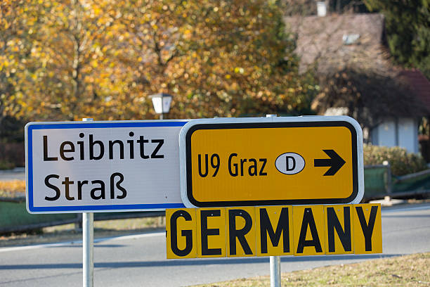 istock refugees in austria,road sign to germany 495315812