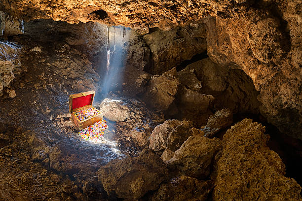 Buried Treasure Cave with skylight streaming sunlight on a treasure chest treasure chest photos stock pictures, royalty-free photos & images