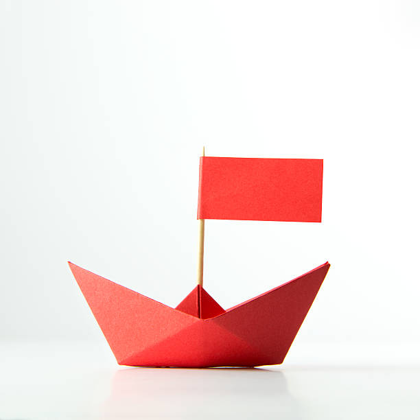 istock Red paper boat with flag 495317620