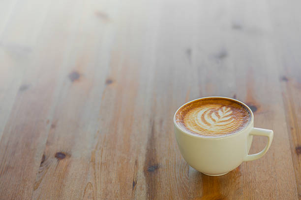 istock Coffee in white cup on wood table 495317964