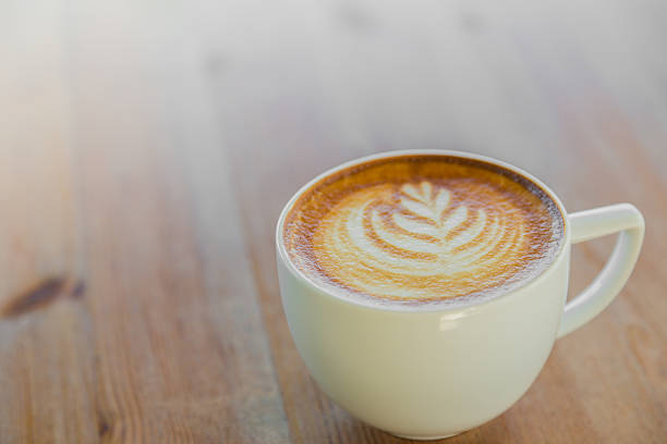 istock Coffee in white cup on wood table 495318030