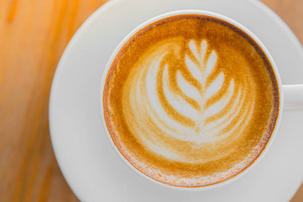 istock Coffee in white cup on wood table 495318080