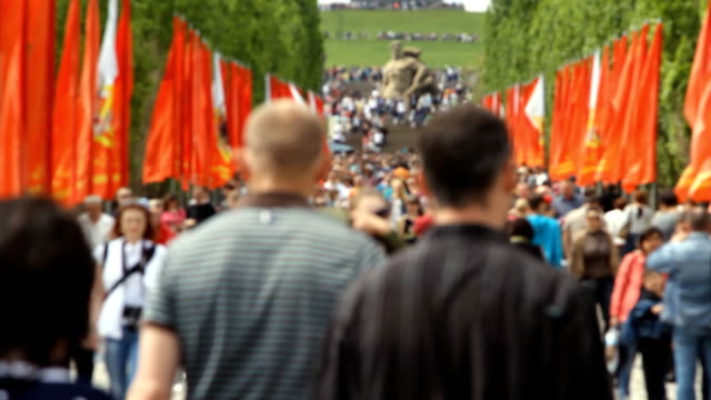 Volgograd, Russian Federation - May 09, 2015: People crowd rises on Mamayev Kurgan. Out of focus.