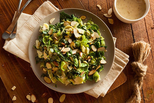 Kale and Brussel Sprout Salad Kale and Brussel Sprout Salad with Almons and Lemon Dressing brussels sprout stock pictures, royalty-free photos & images