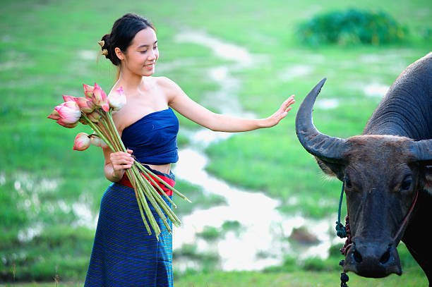 istock thai ancient young women with buffalo on rural 495332088