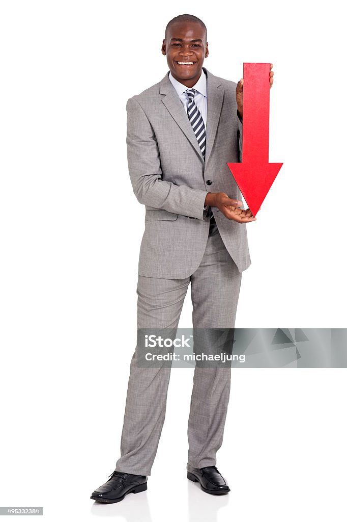 afro american businessman holding red arrow pointing down portrait of afro american businessman holding red arrow pointing down on white background 2015 Stock Photo