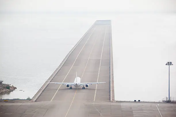 Photo of Rear View of Airplane on Runway Ready to Take Off