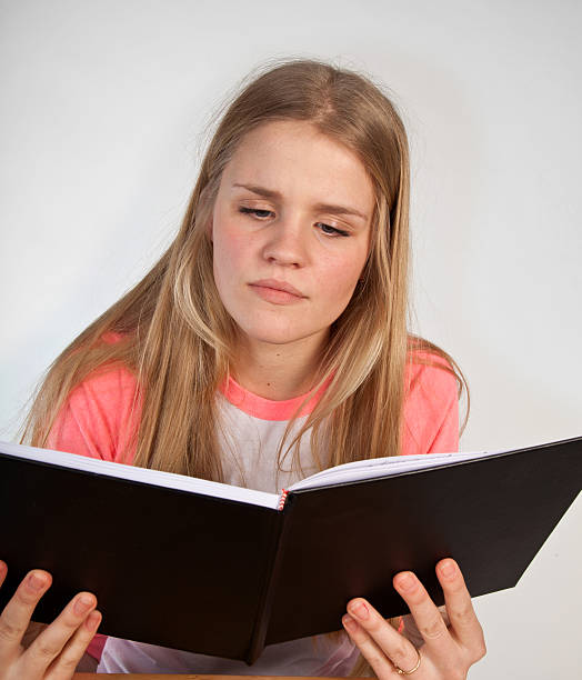 istock Scandinavian cute young girl reading a book 495332466