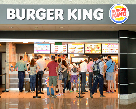 Porto, Portugal- July 9, 2015: Burger King restaurant  at the Francisco Sá Carneiro Airport in Porto.  People in line to buy food.