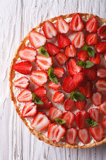 istock Delicious tart with fresh strawberries closeup vertical top view 495333592