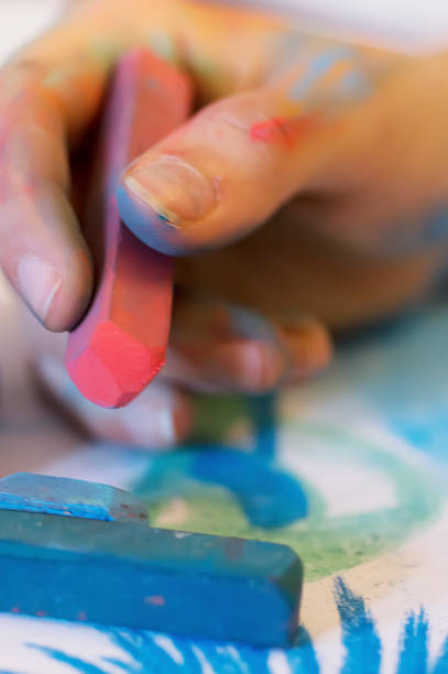 istock young women hand draw with colored chalk 495333789