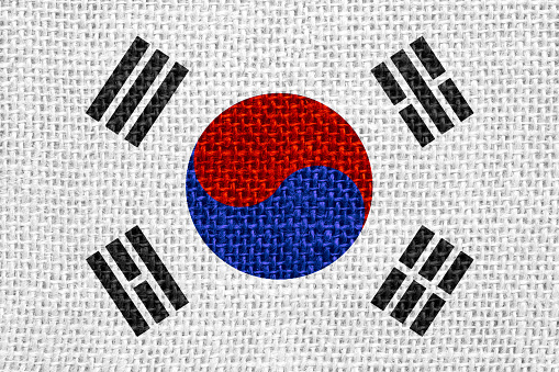 flag of South Korea or South Korean banner on linen background