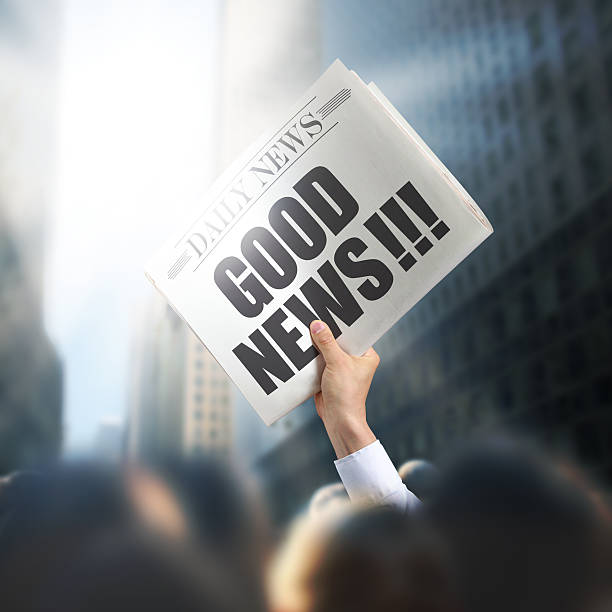 istock Holding Newspaper with Good News 495336803