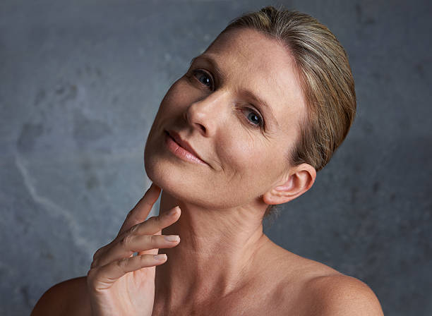 Ageless beauty A mature woman with bare shoulders looking at the camera neck stock pictures, royalty-free photos & images