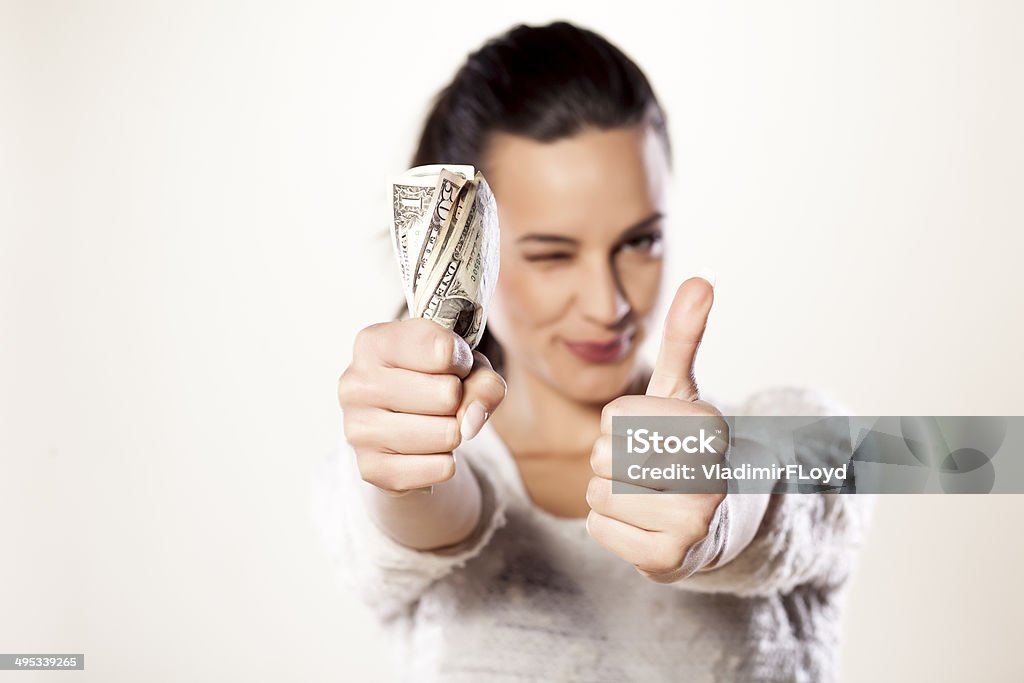 girl with money happy girl holding money and showing thumbs up Currency Stock Photo