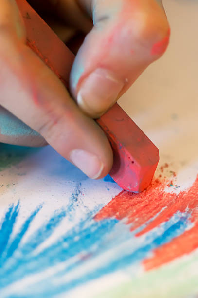 istock young women hand draw with colored chalk 495340055