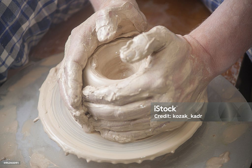 Hands of a potter Hands of a potter, creating an earthen jar on the circle Adult Stock Photo