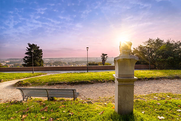 Statue and bench in the Gianicolo park at sunrise stock photo