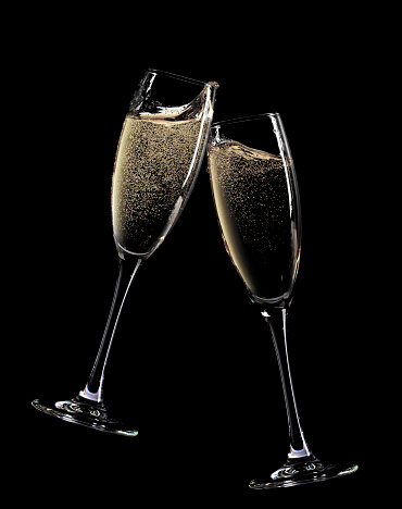 Cheers! Two champagne glasses. Isolated on black background