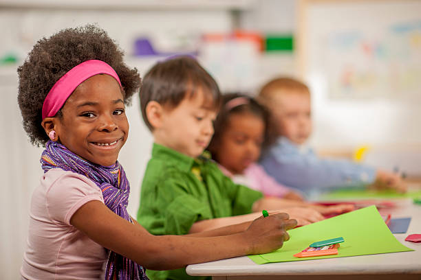 istock Little Girl Coloring at School 495342966