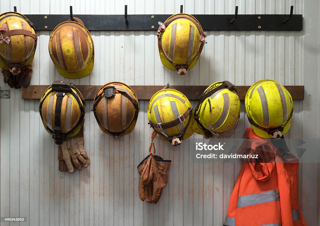 Safety helmets Safety helmets and gloves hang from a rack on a mining site Mining - Natural Resources Stock Photo