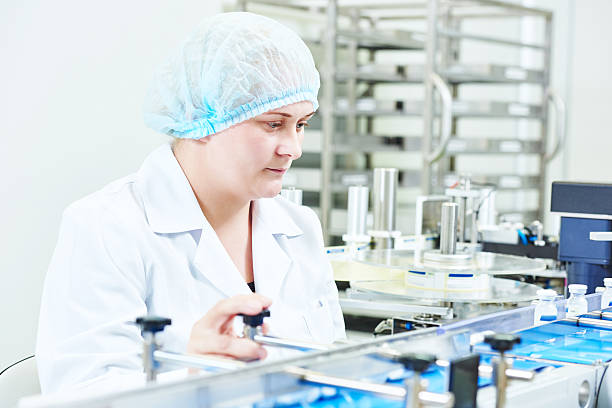 istock factory woman worker operating production line 495346664