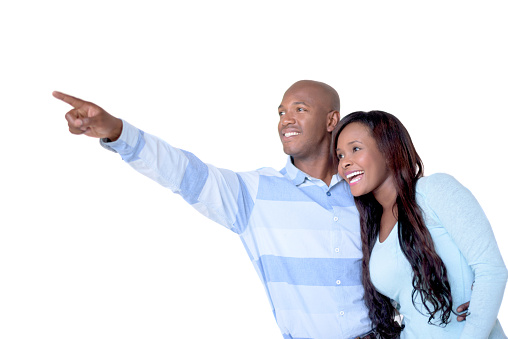 Loving African American couple pointing away with a finger - isolated over a white background