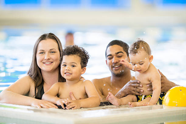 istock Parents Taking Their Little Children Swimming 495348406
