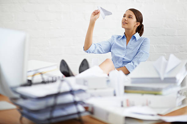 istock Ignoring the paperwork... by making paper planes 495350989