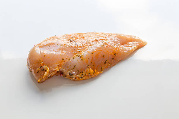 Chicken steak in marinade raw as Cut stock photo