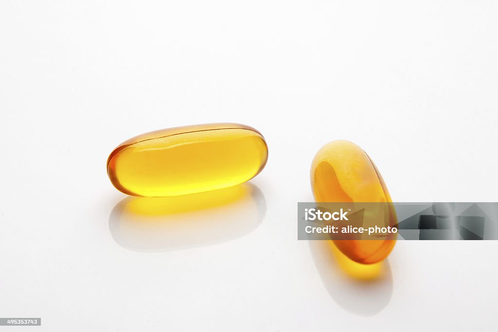 Vitamin fish oil capsule on white background Canon EOS 5d mark2, lens 24-70 2.8 L in studio with soft box.Canon EOS 5d mark2, lens 24-70 2.8 L in studio with soft box. Analyzing Stock Photo