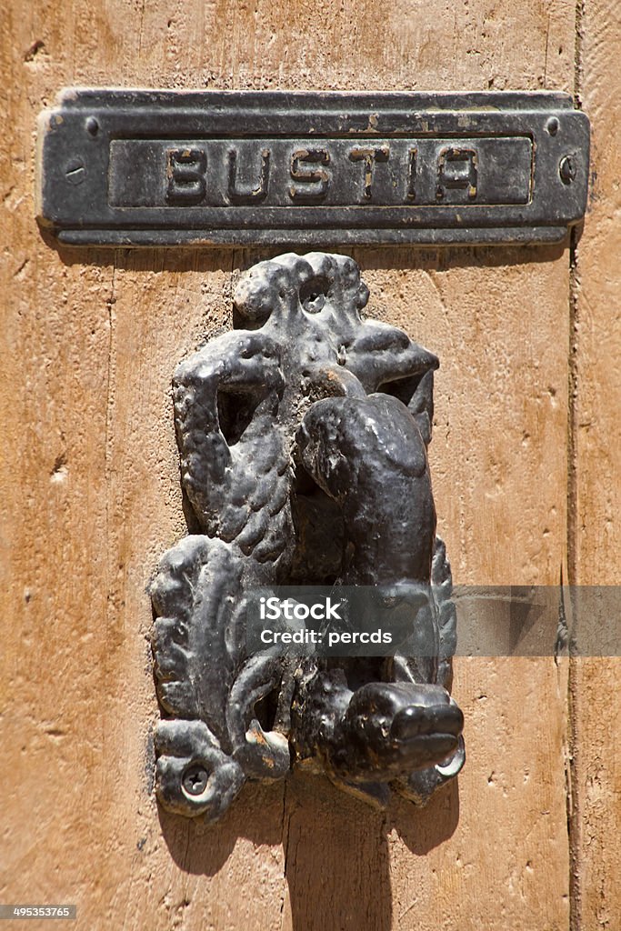 Postbox and door knocker Ancient postbox (bustia in catala language) and carved  door knocker Ancient Stock Photo