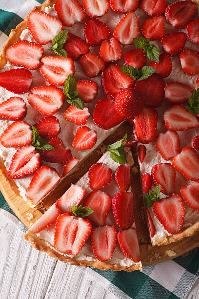 istock sliced strawberry tart closeup. vertical top view 495353866