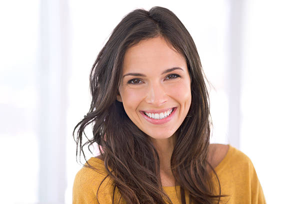 Living a happy life Cropped shot of a gorgeous young woman at home brown hair stock pictures, royalty-free photos & images