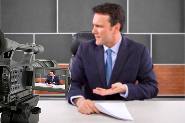 istock Camera Filming a Reporter or Anchorman in a Studio 495354445