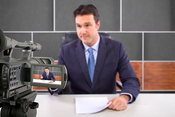 istock Camera Filming a Reporter or Anchorman in a Studio 495354449