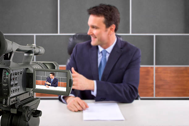 istock Camera Filming a Reporter or Anchorman in a Studio 495354451