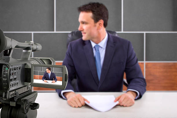 istock Camera Filming a Reporter or Anchorman in a Studio 495354455