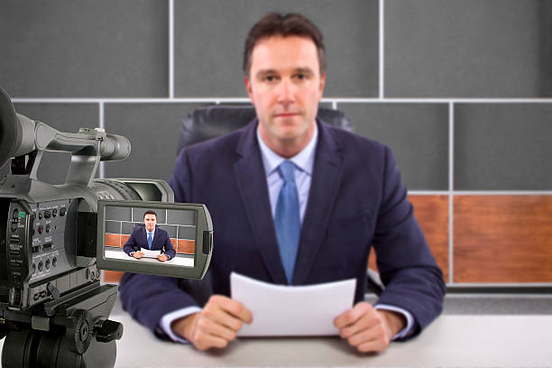 istock Camera Filming a Reporter or Anchorman in a Studio 495354463
