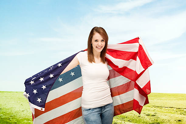istock Cheerful woman holding American flag 495354483