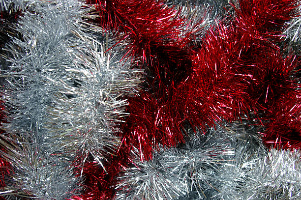 istock Christmas tinsel silver and red texture black background 495354952