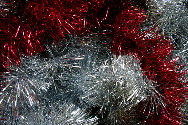 istock Christmas tinsel silver and red texture black background 495355140