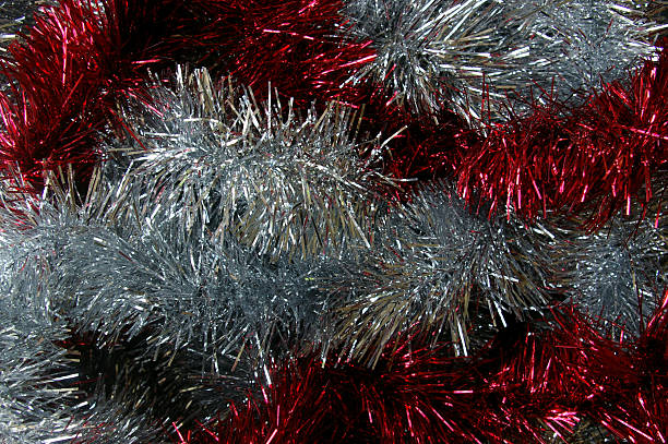 istock Christmas tinsel silver and red texture black background 495355322