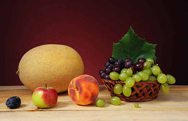istock Fresh melon, peaches and grapes in a wicker basket 495355649