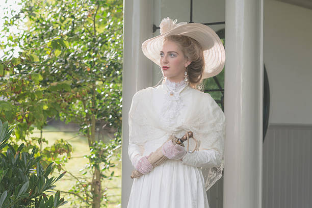 istock Vintage posh victorian woman with hat standing in bower. 495356476