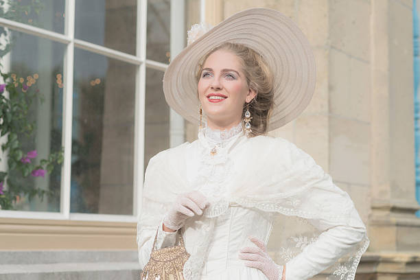 istock Smiling chic victorian woman with hat in front of window. 495356636