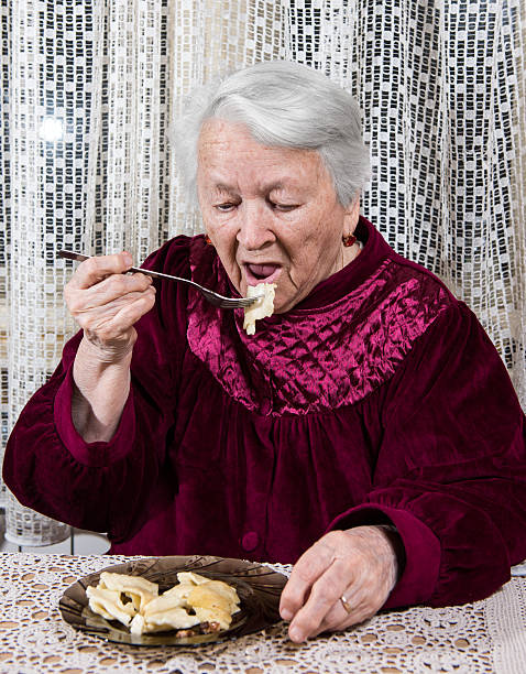 istock Old woman eating at home 495357778