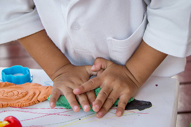 istock Child hand playing with clay, play doh 495359204