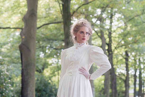 istock Retro victorian woman in front of tree row. 495359592