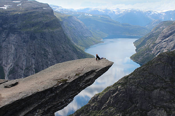 istock Young girl on the Troll's tongue (norw. Trolltunga). 495372994